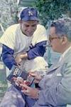 Story Title: "Author" Berra Hits Homer. Author discusses book with O'Brien. Mates gave him "Yogi" tag, saying he resembles Hindu Fakir. Photographer Louis Jaques. Date. May 6, 1961 6 May 1961.