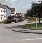 ILC84-283 Fallex 84 Bavaria West Germany. Two leopard tanks park along a street in small German village, during a break in the action, as part of the annual NATO fall manoeuvres September 1984.