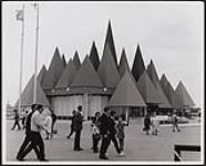 View showing visitors wandering about outside pavilion 1967
