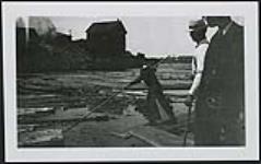 Gilmour & Hughson Ltd.'s Lumbering Activities in Ottawa and Outaouais, ca. 1910- "Gilmour & Hughson Ltd. shewing use of the 'pike-pole' at the base of the 'jack-ladders'. Preparing the logs for entry to the mill" [ca. 1910]