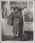 Promotional photograph: Woman with Ontario travel posters années 1930.