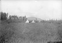 Camp in the valley of the Nisling River [graphic material] 1898.