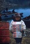 [Young Inuk boy unloading a box]. Original title: Young Eskimo Unloading 19 September 1958