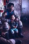 [Interior shot of an Inuit man and child] May 1966