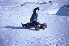 [Inuit boys roughhousing] May 1966
