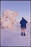 [Inuk man walking around ice formations] [between 1953-1969]