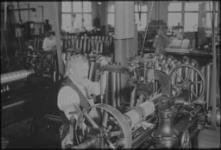 [Man working press] [ca. 1920]