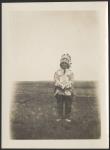 [Man wearing beaded and fringed shirt and headdress of Plains First Nation style] [ca. 1916]