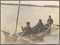 [Two First Nations boys paddling a canoe with man sitting in middle, on Chandalar River]. Original title: Chandlar River Indians [between 1889-1942].