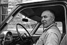 [Portrait of Councillor Reginald Scero, Kanien'keha:ka (Mohawk) from Tyendinaga, sitting in the driver's seat of a car, with the door open] [ca. 1959]