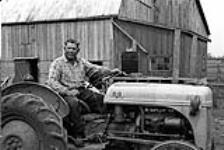 [Chief William Hill, Kanien'keha:ka (Mohawk) from Tyendinaga, sitting on a tractor] [ca. 1959]