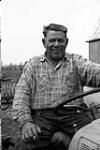 [Chief William Hill, Kanien'keha:ka (Mohawk) from Tyendinaga, sitting on a tractor] [ca. 1959]