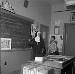 [Nun teaching a young Mi'kmaq student] [between 1900-1976]