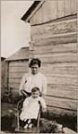 [Anishinaabe woman with her daughter at Wiikwemkoong First Nation. They were identified as Peter Jones' daughter and granddaughter] [ca. 1916]