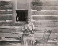 [Mrs. David Jack weaving a belt sash] 1915