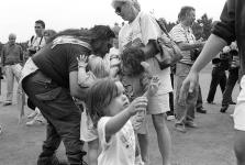 Crowd of young children and adults gathered on golf course 11 July 1995
