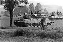 Fallex 77. An old German farm lady is totally oblivious to the huge Leopard of the RCO's as it rolls past during Ex. Carbon Edge. 27 Sept. 77 27 September 1977.