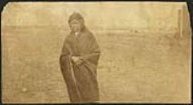 [First Nation individual wrapped in blanket] [ca. 1885]