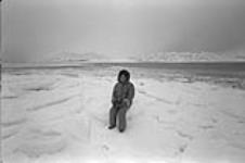 [Portrait of Kenojuak Ashevak sitting in snow] November 1980.