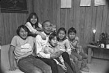 [Oshoochiak Pudlat at home with his grandchildren] December 1980
