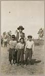 [Donald McKeever (Anishinaabe-Scotch), with three boys] 1920