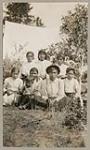[Anishinaabe family seated outside] 1920