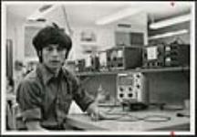 [Unidentified young man seen in a classroom with radio equipment] [ca. 1960-1976]
