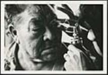 [Man receiving an eye exam] [ca. 1950-1970]