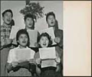[Unidentified teenagers singing Christmas carols] [ca. 1950-1960]
