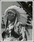 [Unidentified man wearing a Plains style headdress] [ca. 1950-1960]