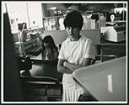 [Young woman in a grocery store] [ca. 1950-1970]