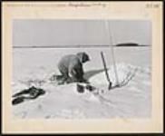 [Ice fishing on Weagamow First Nation] [ca. 1950-1960]