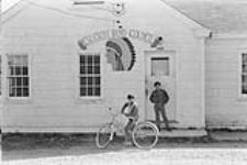 Tom Stevens and David Denny, outside the Eskasoni Band Council office] [Eskasoni Mi'kmaq] [ca. 1969].
