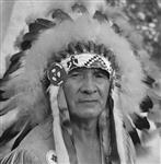 [A close-up of Gordon S. Martin, Chief Floating Sky. Chief Floating Sky can be seen in costume as Master of Ceremonies from the Six Nations Pageant, held in the Forest Theatre]. Original title: Photograph is a close-up of Gordon S. Martin. His Indian name is Chief Floating Sky. Chief Floating Sky can be seen in costume as Master of Ceremonies from the Indian Pageant, held in the Forest Theatre August 1961