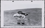 [Inuk woman carrying her child in amauti] October 1956