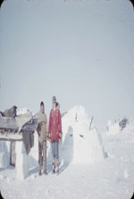 [Inuk man and J.V. Jacobson standing next to qamutiik (sled) on ice pillars] [between 1950 and 1960]