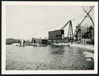 [View of work shanties and Champlain Bridge construction site on river] cira 1924-1928.