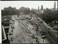 [Overhead view of Confederation Square during construction of the National Memorial and the widening of Plaza Bridge] [October 1938]