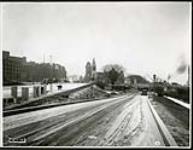 [Stretch of road leading through the western archway of the newly expanded Plaza Bridge] November 30, 1938