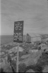 [Police sign in Inuktititut and English about keeping dogs tied up while in the settlement] 1949