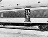 [View of two men standing in doorway of railway carriage] [graphic material] [19-]