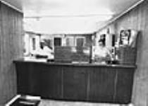 [Man and woman at counter of Masham, Que., post office] [graphic material] August 1971