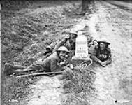 Two men of 75th Infantry Battalion with their prisoner near the last mile stone to Cambrai. Advance East of Arras. October, 1918 October, 1918.