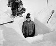 Digging hole to obtain thickness of ice, Fullerton [Harbour], N.W.T., [Winter, 1903-1904] [Winter, 1903-1904]