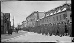 [Royal Military College cadets marching along Bagot St., Kingston, Ont., c. 1916.] 1916