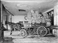 Loaded mail wagon, Post Office in Montreal, P.Q., May 1928