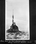 Cairn built by Capt. Kellett in 1854 on Dealy Island, [N.W.T.], 30 Aug., 1910 30 Aug. 1910