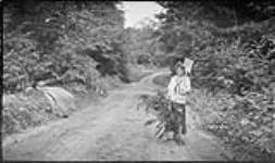 Edna [Boyd] with a basket of ferns and a shovel, Bala, [Ont.], 15 Aug., 1917 August 15, 1917.