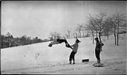 Boy turning a back somersault while tobogganing in High Park [Toronto, Ont.], 9 Feb., 1918 February 9, 1918.