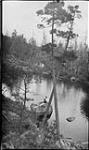 Edna Boyd and Grace Procton sitting on a rock at Long Lake at Bala, [Ont.] Aug., 1918